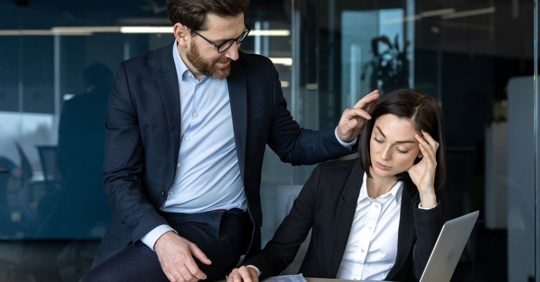 Male employee making lewd gestures and inappropriately touching his female coworker.