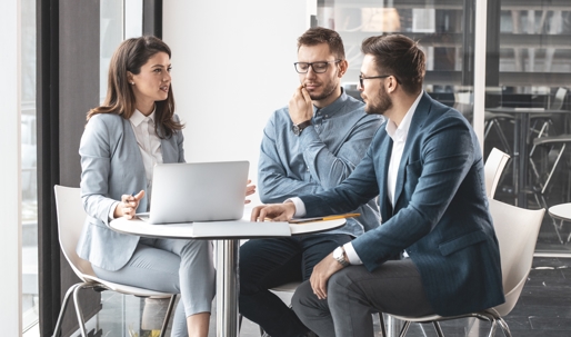 women in an office around men