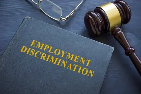 Law about employment discrimination and gavel on the table.