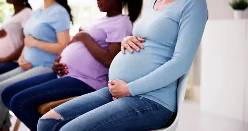 Signature, documents and hands of pregnant woman in office for maternity leave application. Pregnancy, workplace and person with pen for paperwork, forms and contract for parental benefits at company