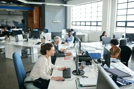 Everyones one hundred percent focused in this office. Shot of colleagues working on their computers while sitting in an office.