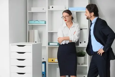Young businessman molesting his secretary in office. Harassment concept