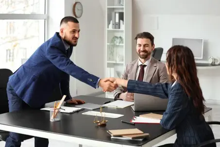 Clients shaking hands at court mediator's office