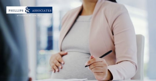 a closeup of a pregnant employee working